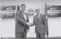  ?? ?? Former Finance secretary Benjamin Diokno officially turns over the Department of Finance leadership to newly appointed Finance secretary Ralph Recto in a ceremony in Manila on Monday, Jan. 15. The turnover ceremony was followed by a series of briefings for Recto, led by the heads of DOF offices.