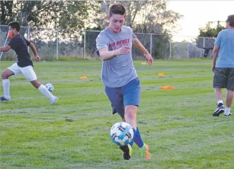  ?? JAMES BARRON/THE NEW MEXICAN ?? St. Michael’s senior Aiden French passes the ball during drills at Christian Brothers Athletic Complex. French moved from the midfield to become a defender, and his presence has helped St. Michael’s start the season 3-1-1.