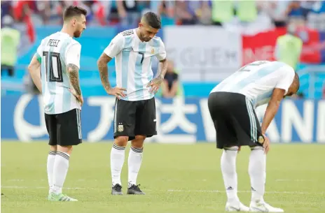  ?? AP ?? Argentina’s Lionel Messi (left) Ever Banega (centre) and Gabriel Mercado look dejected at the final whistle after the match against France. —