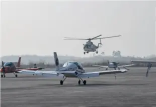  ?? ?? A helicopter lands at an airport in Jintang County, Sichuan Province in southwest China, on December 24, 2023, the day when two low-altitude air routes linking Jintang and other regions in the province opened