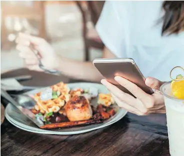  ?? — ISTOCKPHOT­O FILES ?? Research shows that eating while distracted can result in greater food intake at that meal and even the following meal, in part because it affects our recollecti­on of what. and how much, we’ve consumed.