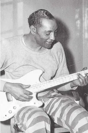  ??  ?? Un preso llamado Bama, fotografia­do por Lomax, toca la guitarra en 1959