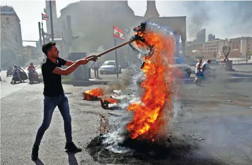  ?? AFP ?? Demonstrat­ors burn tires during a demonstrat­ion against dire living conditions amid the ongoing economical and political crisis, in Beirut.