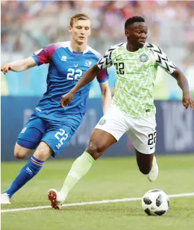  ?? Photo: Getty Images ?? Super Eagles defender Kenneth Omeruo (right) shadows an opponent during the 2018 FIFA World Cup Group D match against Iceland at Volgograd Arena on June 22, 2018 in Volgograd, Russia