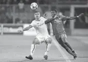  ?? SPADA AP ?? Roma’s Gianluca Mancini, left, vies with David Okereke of Cremonese, which ended a long drought in Serie A.
