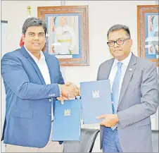  ?? Picture: SUPPLIED ?? Permanent secretary for the Office of the Prime Minister Yogesh Karan and Telecom Fiji Ltd CEO Charles Goundar (left) after the MOA signing.