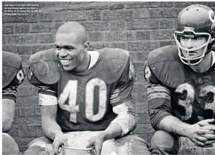  ?? PAUL CANNON/AP ?? Gale Sayers is all smiles after scoring six touchdowns against the 49ers in the Bears’ 61-20 victory Dec. 12, 1965, at Wrigley Field.