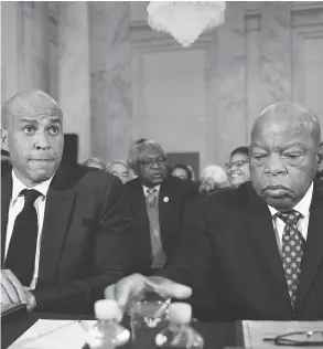  ?? CLIFF OWEN / THE ASSOCIATED PRESS ?? Sen. Cory Booker, left, and Rep. John Lewis testify on Capitol Hill in Washington on Wednesday at the second day of a confirmati­on hearing for Sen. Jeff Sessions.