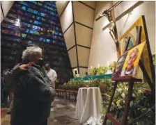  ?? AP PHOTO/FERNANDO LLANO ?? Faithful mourn in front of the photos of Jesuit priests Javier Campos Morales and Joaquin Cesar Mora Salazar on Tuesday during a Mass at a church in Mexico City.