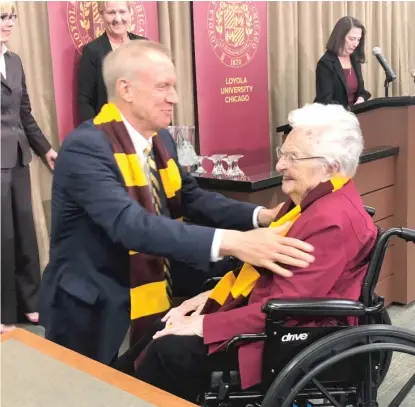  ?? TINA SFONDELES/SUN-TIMES ?? Gov. Bruce Rauner visits with Loyola University men’s basketball team chaplain Sister Jean Dolores Schmidt on Friday.