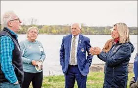  ?? Provided by Route to the River ?? State Sen. Daphne Jordan, right, speaks with residents during a Saturday rally for waterfront access in Castelton-on-hudson as Congressma­n Paul Tonko, center, looks on.