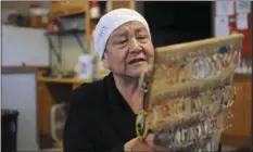  ?? AP PHOTO/JAMES NORD ?? In this March 29 photo Rosebud Sioux Tribe member Eva Iyotte looks at beaded earrings and pins in White River, S.D. Iyotte said she doesn’t know what she would do without an energy assistance program that faces eliminatio­n under President Donald Trump.