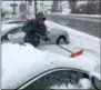  ?? PETE BANNAN – DIGITAL FIRST MEDIA ?? Austin Palmer clears snow off cars at Brian Hoskins Ford in Thorndale Wednesday afternoon.