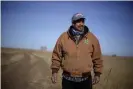  ??  ?? Rod Bradshaw stands in a field of wheat on his farm near Jetmore, Kansas on 13 January 2021. Joe Biden’s nomination of Tom Vilsack to lead the agricultur­e department is getting a chilly reaction from many Black farmers who contend he didn’t do enough to help them the last time he had the job. Photograph: Charlie Riedel/AP