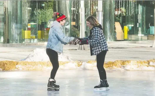  ?? BRANDON HARDER ?? Jayde Richter, left, and Skyla Roulston skate outdoors at Victoria Park. The rink’s Skate Shack, which offers free skate rentals, is closed on Jan. 1.