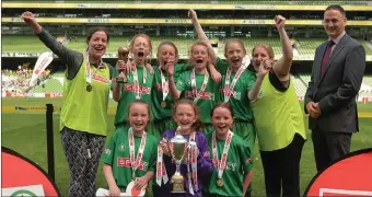  ??  ?? The Drimina NS team and coach Ruth Kelly celebrate with the Cup.