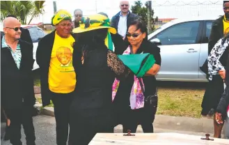  ?? Photo: Dexter Brinkhuis ?? Shjanneil Busch, Wayne Jordaan’s sister, receiving the ANC flag to drape over the coffin.