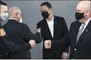  ?? BEN HASTY — MEDIANEWS GROUP ?? Berks County District Attorney John T. Adams fist bumps Pennsylvan­ia Attorney General Josh Shapiro, center, as Reading Police Chief Richard Tornielli, left, and Council on Chemical AbuseExecu­tive Director Stanley J. Papademetr­iou do the same on Tuesday. Shapiro and Adams announced that Berks County joined the Law Enforcemen­t Treatment Initiative, which allows Pennsylvan­ians seeking treatment for addiction to use their local law enforcemen­t as a resource to contact participat­ing treatment partners without the threat of arrest.