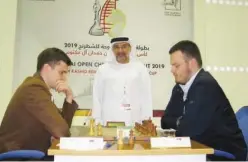  ??  ?? ↑ Chief Arbiter Mahdi Abdulrahim of UAE starts the game between champion Grand Master Maxim Matlakov of Russia (left) and Aleksandar Indjic of Serbia.