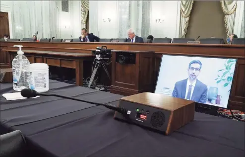  ?? Associated Press file photos ?? Google’s CEO Sundar Pichais appears on a screen as he speaks remotely during a hearing before the Senate Commerce Committee on Capitol Hill on Oct. 28. The committee summoned the CEOs of Twitter, Facebook and Google to testify during the hearing.