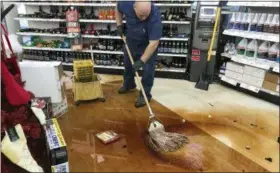  ?? BILL ROTH — ANCHORAGE DAILY NEWS VIA AP ?? Randy Van Ness mops an aisle at Andy’s Ace Hardware after a 7.0-magnitude earthquake hit in Anchorage, Alaska, Friday. Scientists say the damaging Alaska earthquake and aftershock­s occurred on a type of fault in which one side moves down and away from the other side.