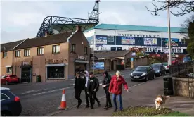  ?? Photograph: Murdo MacLeod/The Guardian ?? People walk past Stark’s Park, home to Scottish Championsh­ip side Raith Rovers.