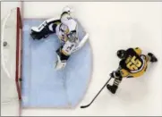  ?? GENE J. PUSKAR — THE ASSOCIATED PRESS ?? The Penguins’ Ron Hainsey gets a shot behind Nashville Predators goalie Juuse Saros during the second period of Game 5 of the Stanley Cup Final on June 8 in Pittsburgh. The Penguins won, 6-0.