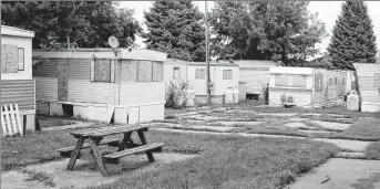  ??  ?? JOHN GURDA PHOTO
Today, 33 boarded-up mobile homes sit on the grounds of the former Jacob Nunnemache­r Distillery.