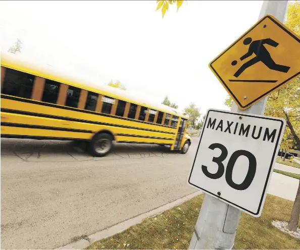  ?? IAN KUCERAK ?? Edmonton city council voted unanimousl­y to expand school zones governed by lower speed limits to include those areas near school playground­s as well, and will also add reflective tape to signposts and motion-activated flashing lights in some areas.