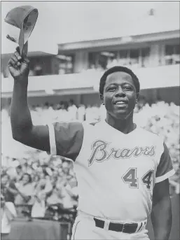  ?? Globe Photos / Zuma Press /TNS ?? In this file image from July 21, 1973, Hank Aaron tips his hat to the crowd after hitting his 700th home run against the Philadelph­ia Phillies in Atlanta.