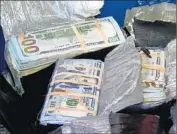  ?? FBI ?? THE METICULOUS­LY WRAPPED currency was found in a box about a foot below the lawn’s surface.