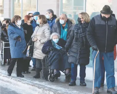  ?? RYAN REMIORZ / THE CANADIAN PRESS ?? Seniors ages 85 and older line up for COVID-19 vaccinatio­ns at a clinic in Laval, Que., on Friday. A third vaccine
was officially authorized for use in Canada on Friday. Twenty million doses have been ordered.