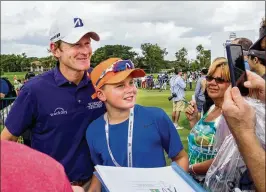 ?? PHOTOS BY RICHARD GRAULICH / THE PALM BEACH POST ?? Jack Breutsch, 12, of Long Island gets a photo with player Brandt Snedeker during the Honda Classic practice rounds Tuesday at PGA National in Palm Beach Gardens.