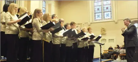  ?? Photos by Eugene Cosgrove ?? Conductor John Casey leading Còr Mhagh Ealla choir at the Festival of Carols last Sunday.