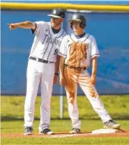  ?? STAFF FILE PHOTO BY ROBIN RUDD ?? Soddy-Daisy coach Jared Hensley instructs Trojans baserunner Javier Everett at third in a 2016 game.