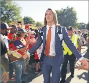  ?? RICHARD SHIRO — THE ASSOCIATED PRESS FILE ?? In this Aug. 29, 2019, file photo, Clemson’s Trevor Lawrence greets fans as he arrives for the team’s NCAA college football game against Georgia Tech in Clemson, S.C. Lawrence and girlfriend Marissa Mowry have restarted their efforts to raise funds for those affected from the coronaviru­s in his Georgia hometown and the area of Upstate South Carolina where their colleges are located.