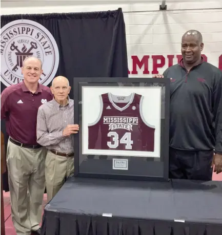  ?? (Submitted photo) ?? Broadcaste­r Jim Ellis, standing middle, was presented a framed No. 34 jersey, by Mississipp­i State men’s head basketball coach Ben Howland, left, and assistant coach George Brooks on Saturday.