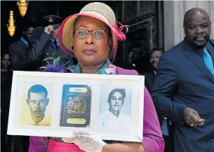  ?? Pictures: ANDY RAIN/EPA, VICTORIA JONES/PA ?? Andria Marsh holds up pictures of her parents and her original British passport