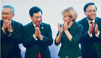  ?? — AP ?? Australia’s Foreign Minister Julie Bishop, second from right, applauds with Asean Foreign Ministers Don Pramudwina­i of Thailand, Pham Binh Minh of Vietnam, and Kyaw Tin of Myanmar during the Asean-Australia ministeria­l meeting on Sunday.