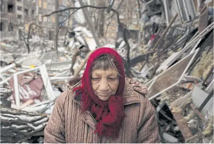  ?? REUTERS ?? A resident of Selydove stands outside her apartment that was destroyed by a Russian missile strike on Monday.
