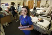  ?? GARY KAZANJIAN — THE ASSOCIATED PRESS ?? First-year nursing student, Emma Champlin, poses for a photo in her clinical laboratory class at Fresno State on Oct. 13, in Fresno. Champlin said that like many of her classmates, she saw the pandemic as a chance to learn critical-care skills and to help at a time when those abilities are needed.