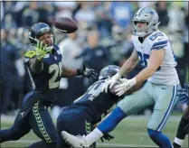  ?? JOHN FROSCHAUER - THE ASSOCIATED PRESS ?? FILE - In this Sept. 23, 2018, file photo, Seattle Seahawks free safety Earl Thomas, left, reaches for a pass he intercepte­d that was intended for Dallas Cowboys tight end Blake Jarwin, right, during the second half of an NFL football game in Seattle.