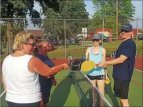  ?? PHOTOS BY BILL RETTEW JR. — DIGITAL FIRST MEDIA ?? Friendly competitor­s bump rackets after a game of pickleball.