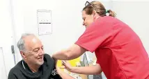  ?? JOHN BISSET/STUFF ?? Peter Wells receives his first Covid-19 vaccinatio­n from Arowhenua Whanau Services practice nurse Siobhan Clancy.