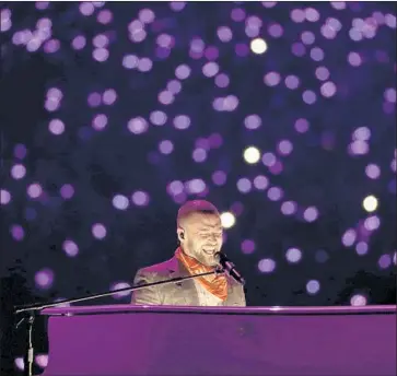  ?? Matt Slocum Associated Press ?? AWASH IN PURPLE lights, Justin Timberlake does his Prince tribute but wisely left out the hologram.