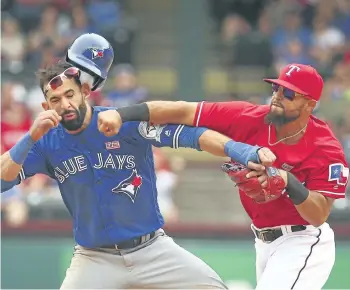  ?? RICHARD W. RODRIGUEZ/STAR-TELEGRAM/AP FILES ?? Toronto’s Jose Bautista is hit by Texas second baseman Rougned Odor in this May 2016 file photo.