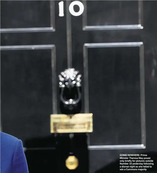  ??  ?? GOING NOWHERE: Prime Minister Theresa May posed only briefly for pictures outside Number 10 yesterday following a dismal night as she failed to win a Commons majority