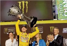  ?? TERRY RENNA / ASSOCIATED PRESS ?? Kyle Busch holds up his trophy in Victory Lane after winning the NASCAR Cup Series season championsh­ip in November at Homestead-Miami Speedway in Homestead, Fla.