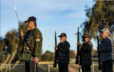  ??  ?? Edward Castillo-Rubio of Vietnam and Global Veterans of Foreign Wars #9305 (left) leads a group of local veterans in a 21-gun salute during the National Vietnam War Veterans Day ceremony held Thursday evening at the Bucklin Park Veterans Memorial.