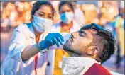  ??  ?? A health worker collects sample from a Hindu devotee to test for Covid-19 during Kumbh Mela festival in Haridwar on April 12.